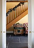 THE FREETH, HEREFORDSHIRE: HALLWAY - SLATE TILES, SLABS, PRINT ROOM YELLOW FROM FARROW AND BALL PAINTED WALLS, STAIRS, STAIRCASE, LOG BASKET, SOFA