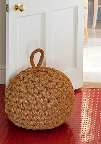 THE_FREETH_HEREFORDSHIRE_KITCHEN_RED_FLOOR_AND_GIANT_DOOR_STOP_MADE_OF_ROPE