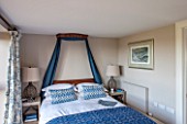 THE FREETH, HEREFORDSHIRE: BLUE BEDROOM - WOODEN CORONET, BED, VELVET BED DRAPES, CUSHIONS