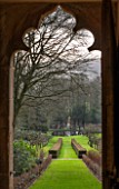 PAINSWICK ROCOCO GARDEN, GLOUCESTERSHIRE: VIEW THROUGH THE DOOR OF THE RED HOUSE IN WINTER. JANUARY, FOLLY, FOLLIES, BUILDING, GARDEN, GOTHIC, TEMPLE, BUILDING