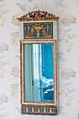 LONDON HOUSE DESIGNED BY JULIE SIMONSEN. BLUE BEDROOM. GUSTAVIAN MIRROR IN GRECIAN STYLE BOUGHT FROM COUSIN. WALLPAPER BY COLEFAX & FOWLER