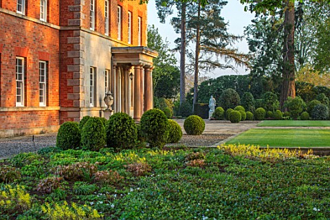 MORTON_HALL_GARDENS_WORCESTERSHIRE_THE_FRONT_OF_THE_HALL_WITH_BOX_TOPIARY_SHAPES__DAWN_LIGHT_MORNING