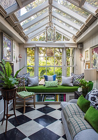 BUTTER_WAKEFIELD_HOUSE_LONDON_THE_CONSERVATORY_WITH_FERNS_AND_GREEN_CUSHIONS_SEATS_SEATING_FURNITURE