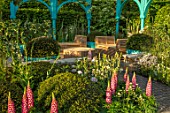CHELSEA FLOWER SHOW 2017: 500 YEARS OF COVENT GARDEN DESIGNED BY LEE BESTALL - COTTAGE GARDEN, FORMAL, BLUE, PAINTED, ARCH, ARCHES, CHAIRS, RATTAN, FURNITURE, RELAXING, LUPINS
