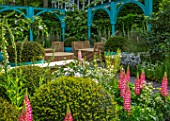 CHELSEA FLOWER SHOW 2017: 500 YEARS OF COVENT GARDEN DESIGNED BY LEE BESTALL - COTTAGE GARDEN, FORMAL, BLUE, PAINTED, ARCH, ARCHES, CHAIRS, RATTAN, FURNITURE, RELAXING, LUPINS