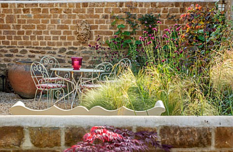 THE_CONIFERS_OXFORDSHIRE_DESIGNER_CLIVE_NICHOLS__SMALL_COURTYARD_GARDEN__TABLE_CHAIRS_STIPA_TENUISSI