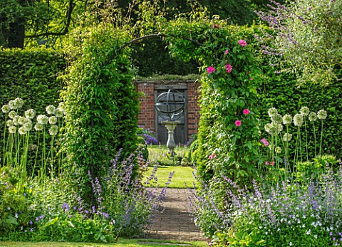 COTTAGE_ROW_DORSET_ARCH_WITH_CLEMATIS_MADAME_JULIA_CORREVON_SUNDIAL_AND_WALL_FRAMED_VIEW_CLIMBERS_CL