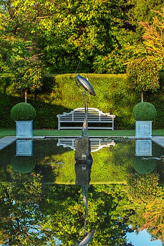 HAZELBY_HOUSE_BERKSHIRE_FORMAL_WATER__POND_POOL_CANAL_WOODEN_BENCH_SEAT_REFLECTIONS_REFLECTED