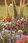 ROGER PARSONS SWEET PEAS, WEST SUSSEX: ROGER PARSONS IN AMONGST THE NATIONAL COLLECTION OF SWEET PEAS AND ECHIUMS GROWING BESIDE A FIELD. DAWN, SUNRISE, LATHYRUS, CUTTING, GARDEN