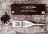 ROGER PARSONS SWEET PEAS, WEST SUSSEX: BLACK AND WHITE IMAGE OF SEEDS, METAL SWEET PEA COUNTER AND SWEET PEA COUNTER BOX