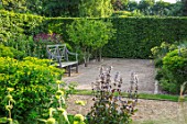 THE OLD RECTORY, QUINTON, NORTHAMPTONSHIRE: DESIGNER ANOUSHKA FEILER: WOODEN BENCH, SEAT AND BOULES COURT. SUMMER, GARDEN, ENGLISH
