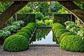 WOLLERTON OLD HALL, SHROPSHIRE: RILL, CANAL, POOL, RECTANGULAR, WATER, HEDGES, HEDGING, SUMMER, REFLECTIONS, AXIS, SYMMETRY, FOCAL, POINT, BOX, BALLS, BUXUS, CLIPPED, TOPIARY