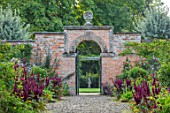 MORTON HALL GARDENS, WORCESTERSHIRE: KITCHEN GARDEN IN LATE SUMMER. BEDS WITH AMARANTHUS, GATE, WALL, WALLED, COUNTRY, HOUSE, CLASSIC, VEGETABLE, ARCH