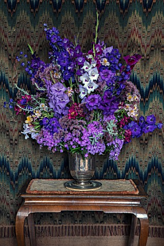 PARHAM_SUSSEX_WEST_ROOM__SILVER_CONTAINER_WITH_DELPHINIUM_BRUCE_GLADIOLI_VELVET_EYES_AND_HOME_COMING