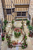 LEEDS CASTLE, KENT: COURTYARD WITH FLOWERS, TWIGS, BRANCHES