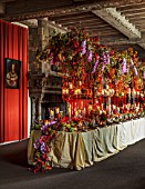 LEEDS CASTLE, KENT: THE DINING ROOM, TABLE WITH CANDLES, FLOWERS, ORCHIDS, CHINESE LANTERNS, PINK, RED, CREAM, DESIGNER SIMON LYCETT