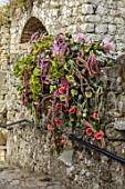 LEEDS CASTLE, KENT: FLORAL DECORATION, FLOWERS, BARBICAN RUINS, FLORAL DESIGN BY TRACY ROWBOTTOM OF COUNTRY BASKETS, ORCHIDS, ROSES, LILIES