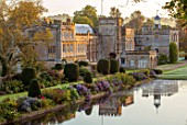 FORDE ABBEY, SOMERSET: VIEW OF THE LONG POND IN OCTOBER, DAWN, SUNRISE, WATER, FORMAL, POND, POOL, CLIPPED, YEW, TOPIARY, AUTUMN, ENGLISH, COUNTRY, GARDEN, REFLECTIONS, REFLECTED