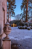 MORTON HALL, WORCESTERSHIRE: WINTER - FROST, SNOW, CLIPPED TOPIARY BOX BALLS, STATUE, NIGHT, MOONLIGHT, COLD, DECEMBER, LIGHTING, LIGHTS, ENGLISH, COUNTRY, GARDEN, URN