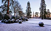 MORTON HALL, WORCESTERSHIRE: WINTER - FROST, SNOW, CLIPPED TOPIARY BOX BALLS, COLD, DECEMBER, ENGLISH, COUNTRY, GARDEN, HEDGE, HEDGING, HEDGES, LAWN, PARKLAND, DAWN, SUNRISE