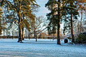 MORTON HALL, WORCESTERSHIRE: WINTER - VIEW FROM EAST TERRACE OF HOUSE TO PARKLAND WITH FROST, SNOW, COLD, DECEMBER, ENGLISH, COUNTRY, GARDEN, SUNRISE, DAWN, LIGHT