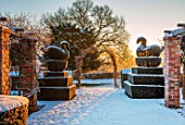 FELLEY PRIORY, NOTTINGHAMSHIRE: WINTER - SNOW, CLIPPED TOPIARY YEW SWANS, ARCH, DECEMBER. ENGLISH, COUNTRY, GARDEN, SUNRISE, DAWN, FROZEN, PERGOLAS