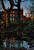 MORTON HALL, WORCESTERSHIRE: NIGHT TIME, LIGHTS, LIGHTING, EVENING, WATER, GARDEN, COUNTRY, HOUSE, TREES, POND, POOL, REFLECTIONS, REFLECTED