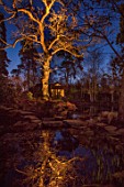 MORTON HALL, WORCESTERSHIRE: NIGHT TIME, LIGHTS, LIGHTING, EVENING, WATER, GARDEN, COUNTRY, HOUSE, TREES, POND, POOL, REFLECTIONS, REFLECTED, JAPANESE TEA HOUSE