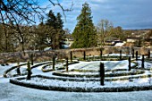 ABERGLASNEY GARDENS, CAMARTHENSHIRE, WALES. UPPER WALLED GARDEN IN SNOW. FEBRUARY, GRASS, FORMAL, PATTERN, PATTERNS, LAWN, PATHS, TOPIARY, CLIPPED, YEW, TAXUS