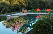 SKOPOS DESIGN, CORFU: BLACK INFINITY POOL WITH REFLECTIONS, ORANGE CHAIRS, TERRACOTTA CONTAINERS WITH AGAVES. REFLECTED, SWIMMING, PONDS, WATER