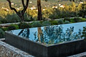 SKOPOS DESIGN, CORFU: RAISED BLACK INFINITY POOL WITH REFLECTIONS OF OLIVE TREES IN WATER. REFLECTED, SWIMMING, PONDS