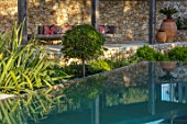 SKOPOS DESIGN, CORFU: RAISED BLACK INFINITY POOL WITH REFLECTIONS IN WATER. REFLECTED, SWIMMING, PONDS, PATIO, TERRACES, TERRACOTTA CONTAINERS, SEATING, CUSHIONS