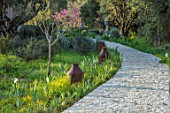 SKOPOS DESIGN, CORFU: STONE PATH ENTRANCE TO GARDEN WITH IRISES AND LIGHTS
