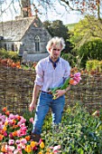 THE OLD PARSONAGE, DORSET: OWNER CHARLIE MCCORMICK PICKING TULIPS IN THE CUTTING GARDEN.