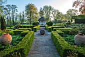 MITTON MANOR, STAFFORDSHIRE: PATH, EMPTY, TERRACOTTA CONTAINERS, TOPIARY GARDEN, FORMAL, COUNTRY, BOX, TOPIARY, HEDGES, HEDGING, EVERGREEN, SPRING, SUMMERHOUSES