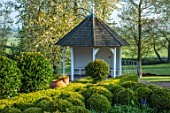 MITTON MANOR, STAFFORDSHIRE: TOPIARY GARDEN, FORMAL, COUNTRY, BOX, TOPIARY, HEDGES, HEDGING, EVERGREEN, SPRING, SUMMERHOUSES