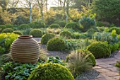 MITTON MANOR, STAFFORDSHIRE: FORMAL BOX TOPIARY GARDEN, SPRING, PATH, CLIPPED, BOX, BUXUS, HEDGES, MOUNDS, HEDGING, EVERGREENS, EUPHORBIAS, COUNTRY, EMPTY, TERRACOTTA, CONTAINERS