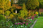 MORTON HALL, WORCESTERSHIRE: BORDER BESIDE LAWN. PINK, WHITE TULIPS AND ROSES. BORDERS, COUNTRY, GARDENS, FLOWERS, FLOWERING, SPRING GREEN, RECREADO, MARIETTE, LASTING LOVE