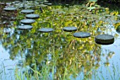 CHILWORTH MANOR, SURREY: STEPPING STONE PATH OVER WATER IN RIGINAL MONASTIC STEWPOND. REFLECTIONS