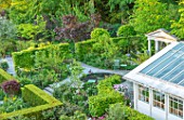 CLAUS DALBY GARDEN, DENMARK: PATHS AND GARDEN ROOMS SEEN FROM THE HOUSE, YEW HEDGES, HEDGING, SPRING, GREENHOUSES, LOGGIA, GARDEN ROOMS