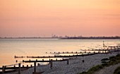 SEASIDE GARDEN DESIGNED BY ANTHONY PAUL: EVENING VIEW TO SEA AND PORTSMOUTH ALONG BEACH