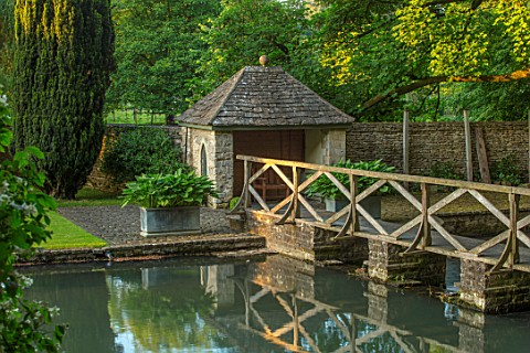 ABLINGTON_MANOR_GLOUCESTERSHIRE_REFLECTIONS_IN_RIVER_COLN_LAWN_SUMMERHOUSE_SUMMER_HOUSE_WOODEN_BRIDG
