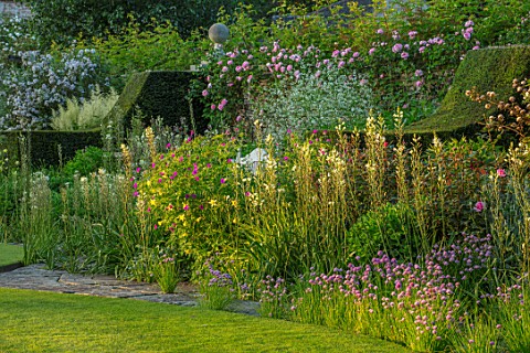 ABLINGTON_MANOR_GLOUCESTERSHIRE_LAWN_STONE_PATH_BORDER_WITH_CHIVES_ROSES_CRAMBE_CORDIFOLIA_BORDERS_S