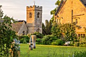 ASTHALL MANOR, OXFORDSHIRE: LAWN, CHURCH, SCULPTURES, ENGLISH, COUNTRY, HOUSE, GARDENS