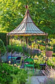 THE WALLED GARDEN AT COWDRAY, WEST SUSSEX: OUTDOOR DINING, SEATING AREA TABLE, CHAIRS, BOX PARTERRES, GREEN, ENGLISH, COUNTRY, GARDEN, AWNING, GAZEBO, AL FRESCO