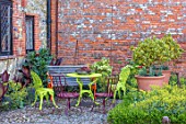 THE WALLED GARDEN AT COWDRAY, WEST SUSSEX: ENGLISH, COUNTRY, GARDEN, TERRACOTTA CONTAINERS, GREEN TABLE, CHAIRS, WALLED, WALLS, PATIO