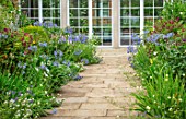 MORTON HALL, WORCESTERSHIRE: THE SOUTH GARDEN: PATHS, BORDERS, AGAPANTHUS BLUE TRIUMPHATOR. SUMMER, GARDENS, FLOWERING
