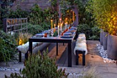 TANYA SOUTHWORTH GARDEN, LONDON, DESIGNER ANOUSHKA FEILER: SMALL GARDEN - TABLE, BENCHES, CANDLES, MIRRORS, CONTAINERS WITH BLACK BAMBOO, LIGHTING, EVENING, NIGHT, FORMAL