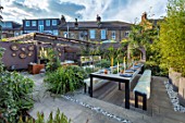 TANYA SOUTHWORTH GARDEN, LONDON, DESIGNER ANOUSHKA FEILER: TABLE, BENCHES, BAMBOOS, CONTAINERS, OUTDOOR LIVING ROOM. SOFAS, FIRE, MIRRORS, RENDERED WALL, SMALL, FORMAL, TOWN, URBAN
