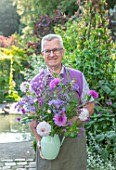 CLAUS DALBY GARDEN, DENMARK: CLAUS DALBY HOLDING A BOUQUET OF FLOWERS FROM THE GARDEN